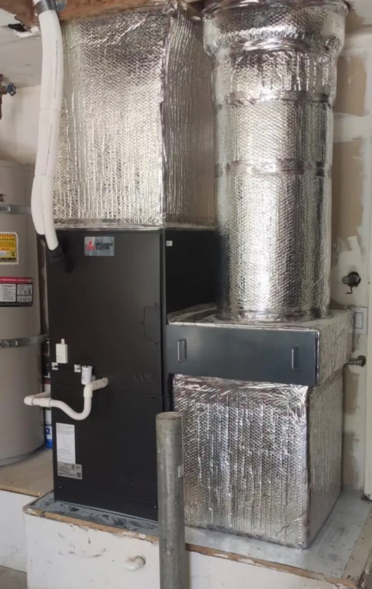 Mitsubishi Electric ducted air handler installed in utility closet with insulated ductwork