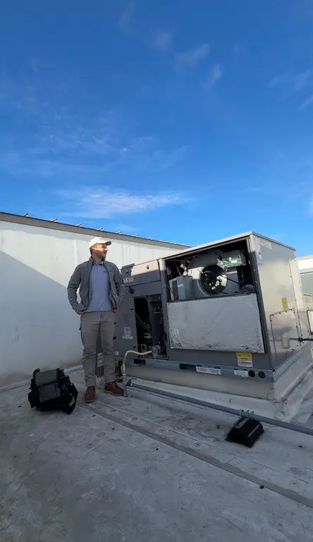 North Breeze technician performing RTU maintenance on rooftop