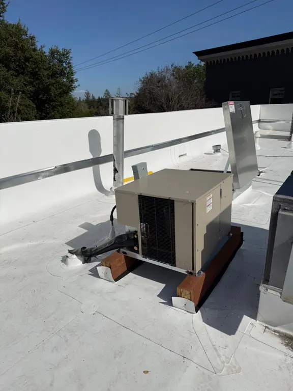 New condensing unit installed on restaurant rooftop