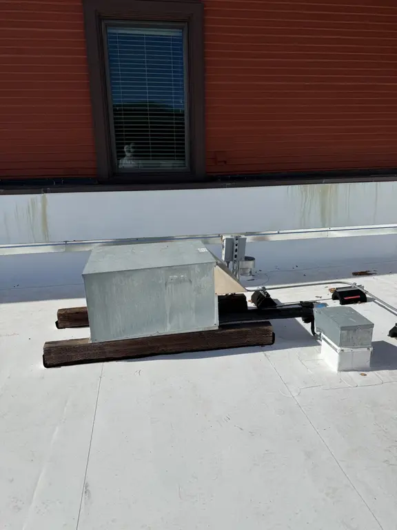 New condensing unit on rooftop before installation