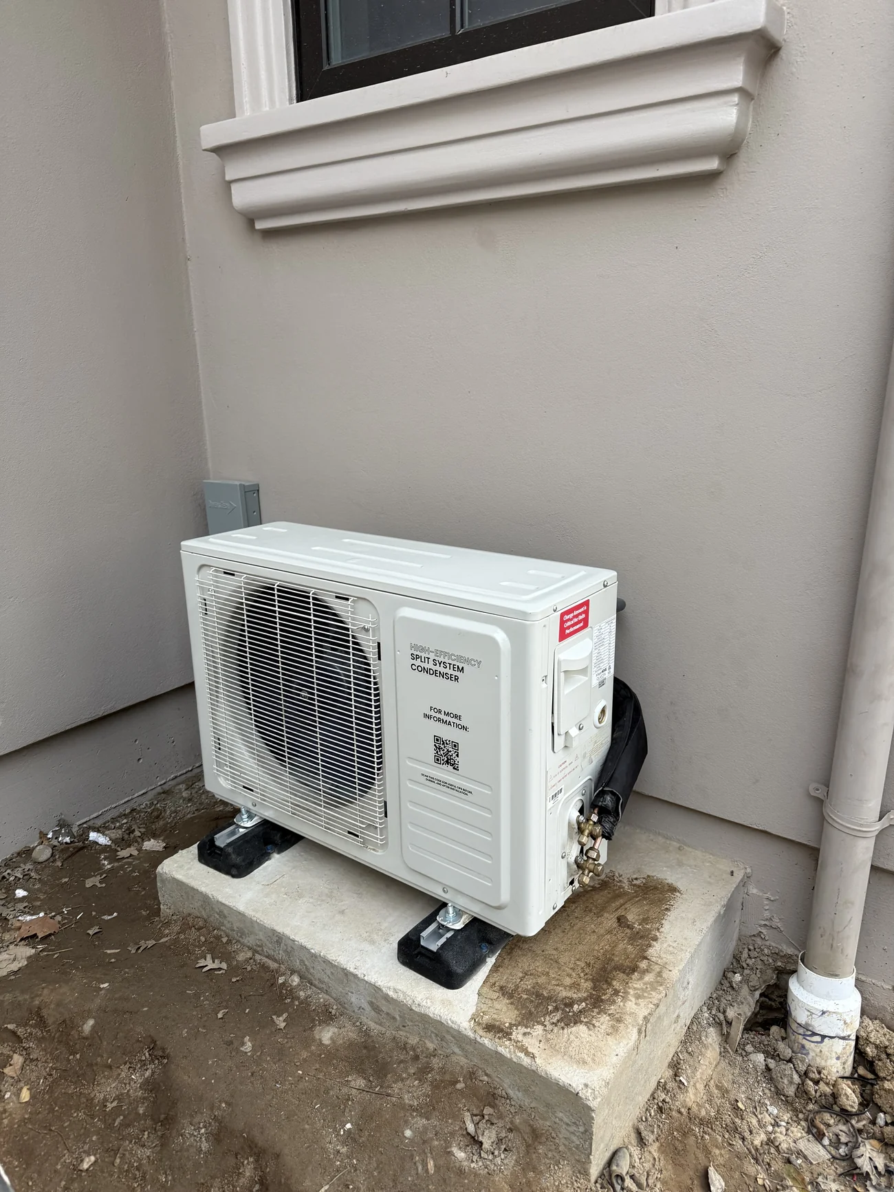 WhisperKOOL CellarCool outdoor condenser properly installed on concrete pad with vibration isolation pads after rework