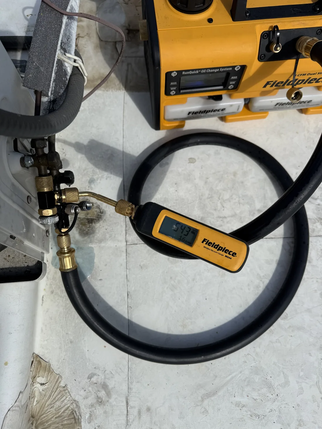 Fieldpiece wireless digital vacuum gauge measuring deep vacuum during WhisperKOOL system evacuation