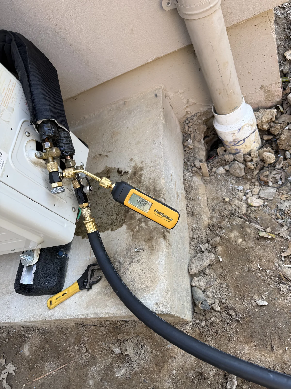 Fieldpiece digital vacuum gauge showing 588 microns deep vacuum during wine cellar cooling system evacuation