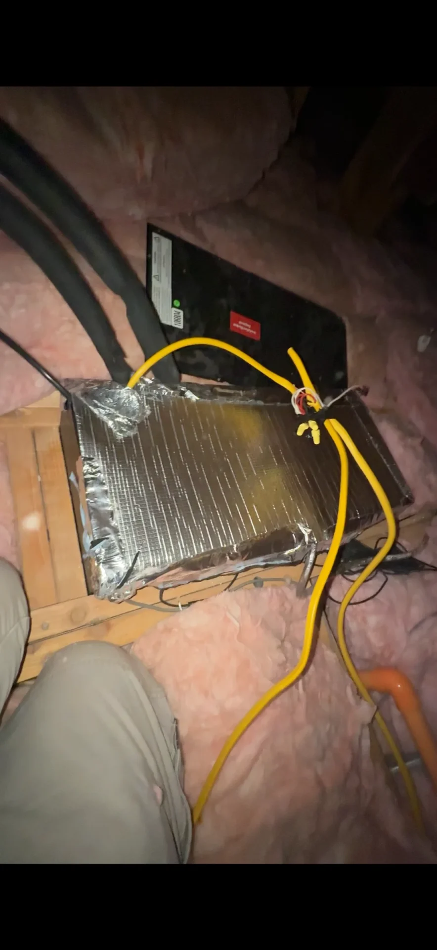 Wine cellar cooling evaporator in attic showing improper original installation with disconnected components