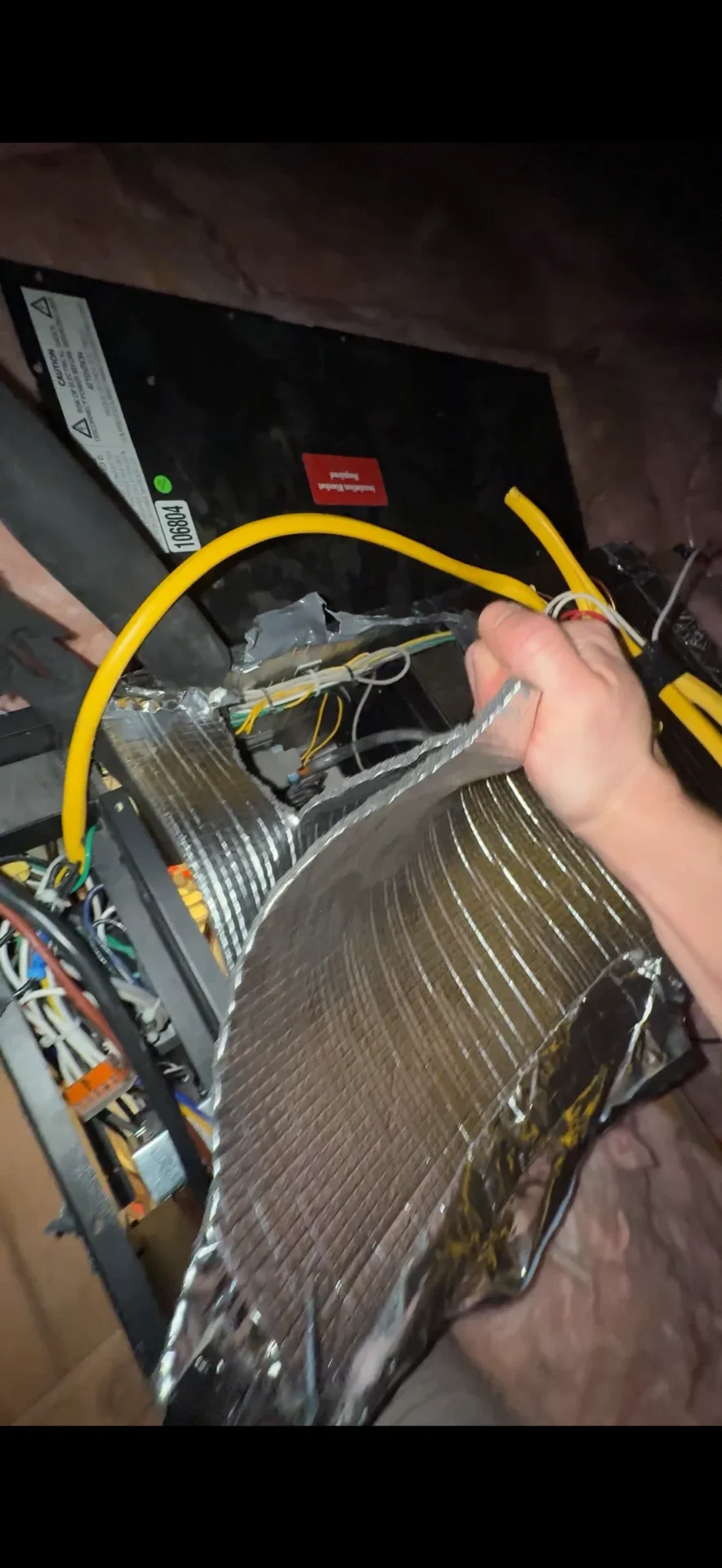 Wine cellar cooling evaporator partially disassembled in attic showing original installation issues