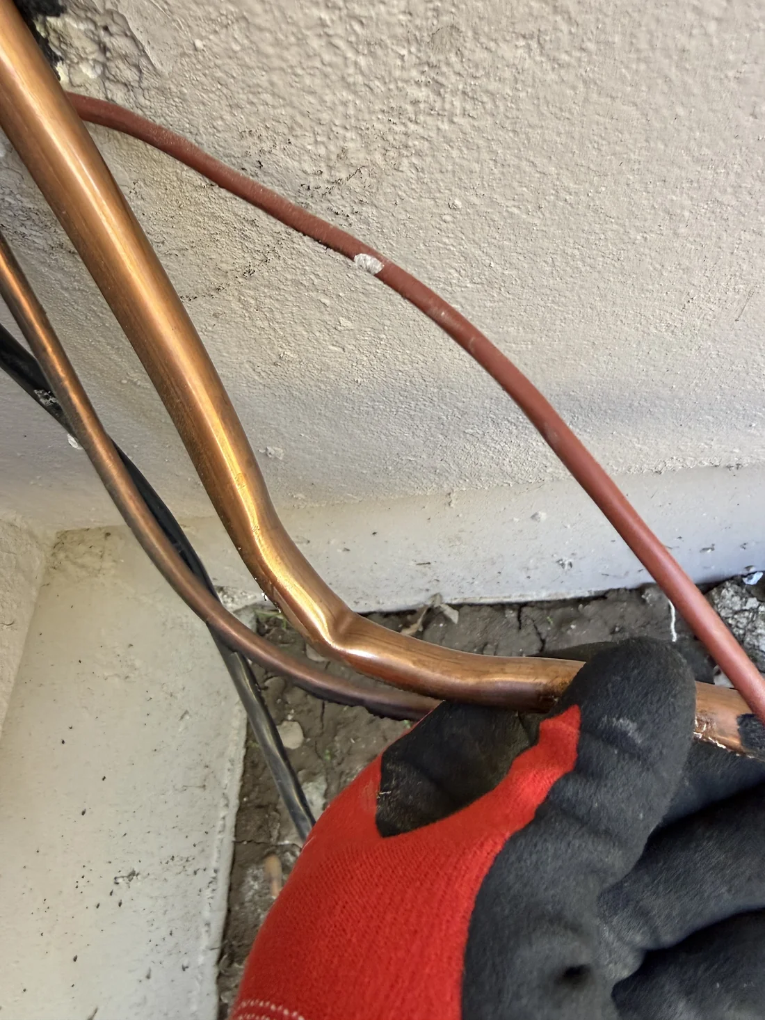 Kinked copper line set discovered during wine cellar cooling system inspection in Bay Area, the bent tubing was permanently damaged by the previous installer